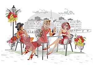 Fashion people in the restaurant. Street cafe in the old city. Girls in red dresses and hats drinking coffee at the table near the